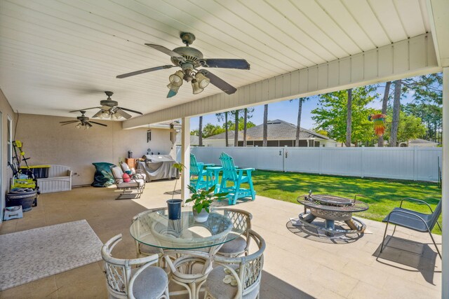 100 Kensington Cir, Panama City Beach, FL 32413 - view of patio featuring an outdoor fire pit, ceiling fan, outdoor dining area, and grilling area