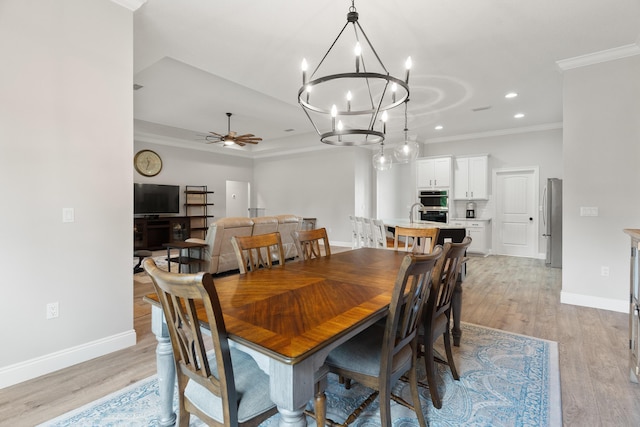 5362 Wyndell Cir, Crestview, FL 32539 - dining area with crown molding, a ceiling fan, baseboards, light wood finished floors, and a chandelier