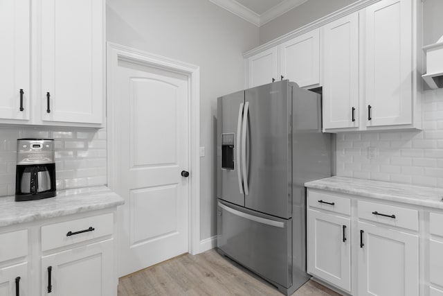 5362 Wyndell Cir, Crestview, FL 32539 - kitchen with stainless steel refrigerator with ice dispenser, ornamental molding, backsplash, white cabinets, and light wood-type flooring