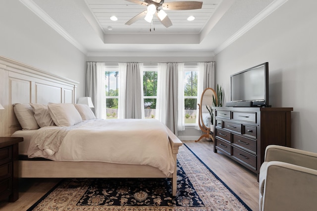 5362 Wyndell Cir, Crestview, FL 32539 - bedroom with multiple windows, light wood-style floors, a tray ceiling, crown molding, and recessed lighting