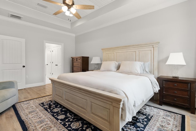 5362 Wyndell Cir, Crestview, FL 32539 - bedroom with a raised ceiling, light wood-style floors, baseboards, ceiling fan, and crown molding