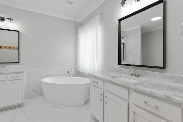 5362 Wyndell Cir, Crestview, FL 32539 - bathroom featuring ornamental molding, a soaking tub, two vanities, marble look tiles, and wainscoting