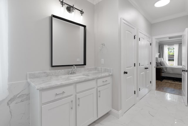 5362 Wyndell Cir, Crestview, FL 32539 - ensuite bathroom featuring marble look tiles, vanity, ornamental molding, and baseboards