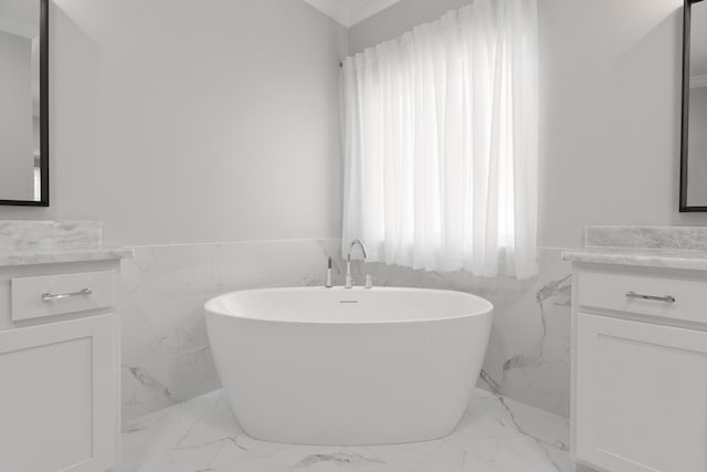 5362 Wyndell Cir, Crestview, FL 32539 - full bath with vanity, marble finish flooring, tile walls, a freestanding tub, and a wainscoted wall