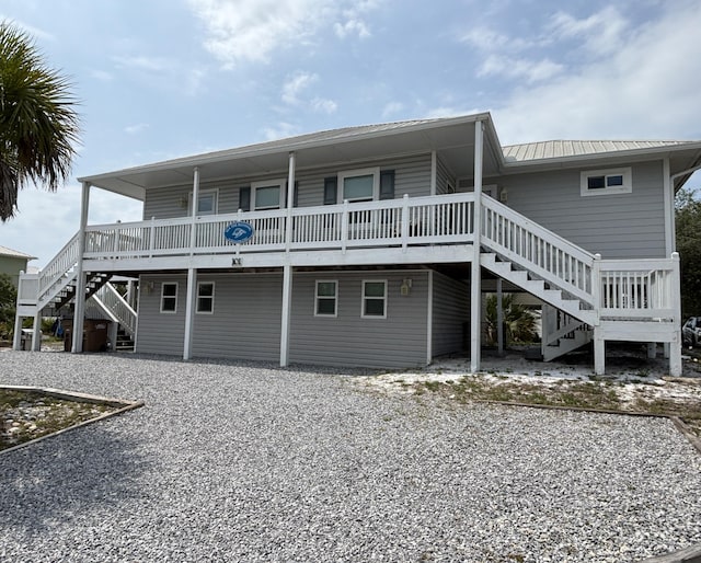 101 Barbados Dr, Cape San Blas, FL 32456 - rear view of property featuring stairs and metal roof