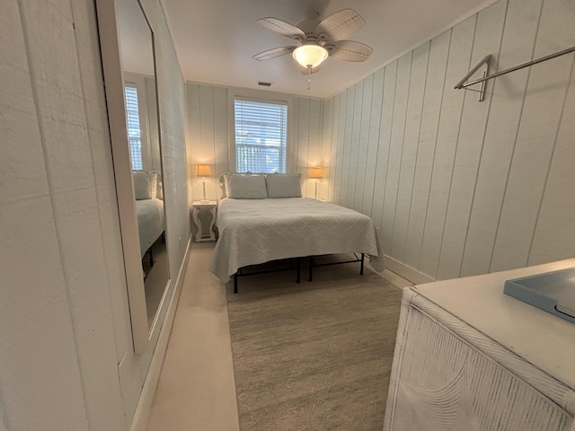 101 Barbados Dr, Cape San Blas, FL 32456 - bedroom featuring ceiling fan and wood walls