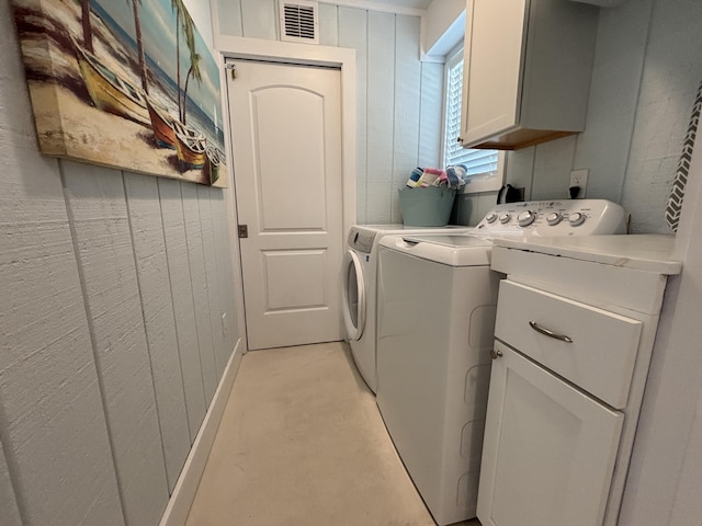 101 Barbados Dr, Cape San Blas, FL 32456 - laundry room with cabinet space, separate washer and dryer, and wooden walls