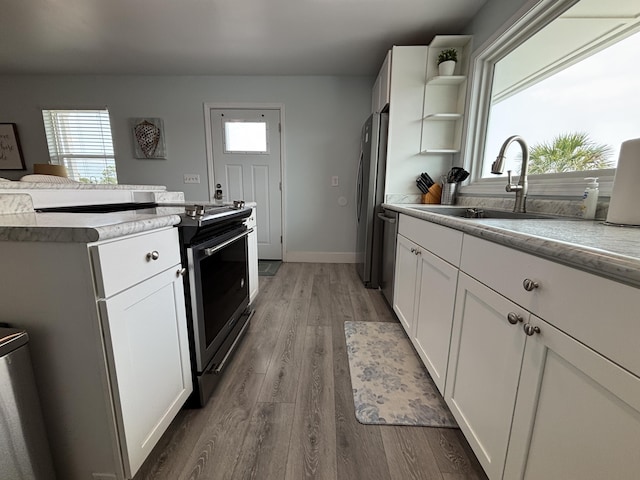 101 Barbados Dr, Cape San Blas, FL 32456 - kitchen featuring appliances with stainless steel finishes, a sink, healthy amount of natural light, and wood finished floors