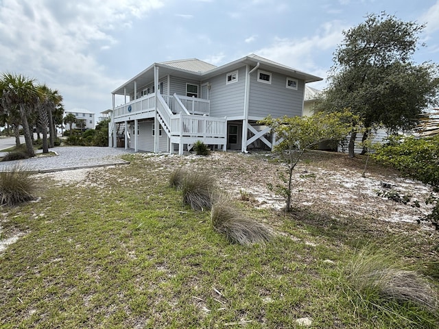 101 Barbados Dr, Cape San Blas, FL 32456 - back of house featuring stairs and a yard