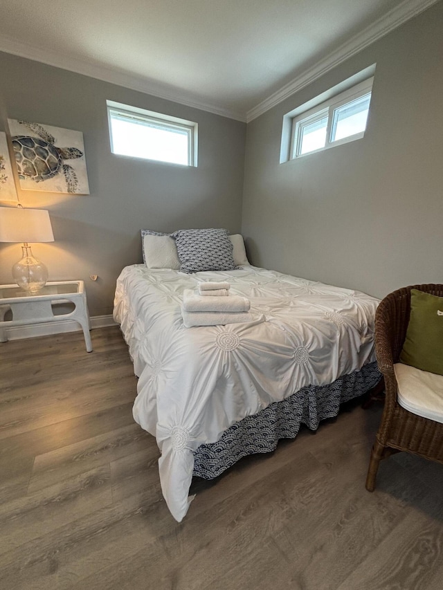 101 Barbados Dr, Cape San Blas, FL 32456 - bedroom featuring crown molding, wood finished floors, multiple windows, and baseboards
