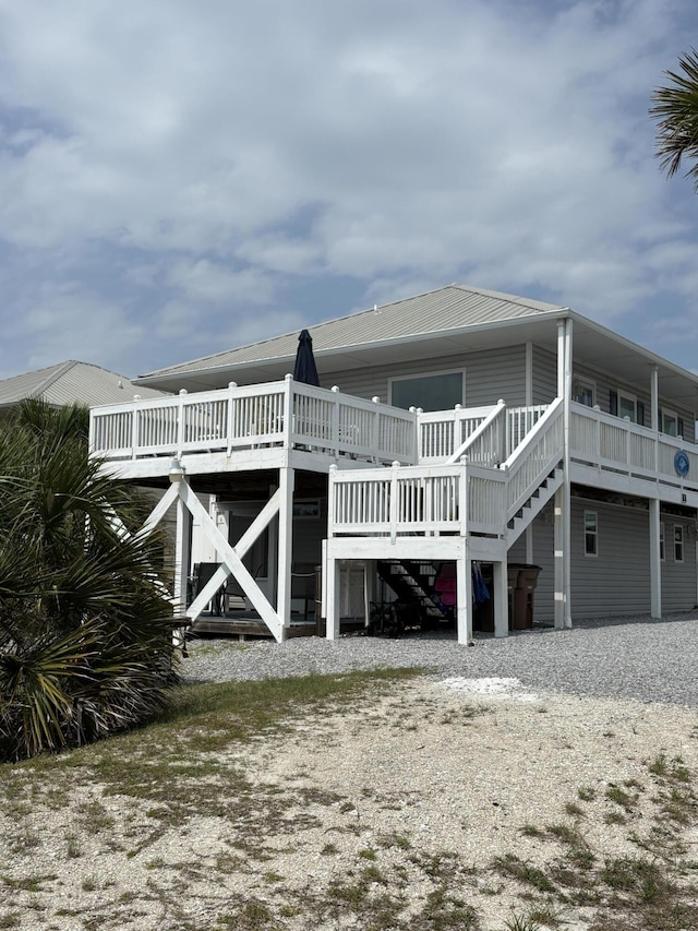 101 Barbados Dr, Cape San Blas, FL 32456 - rear view of house featuring stairway and a wooden deck