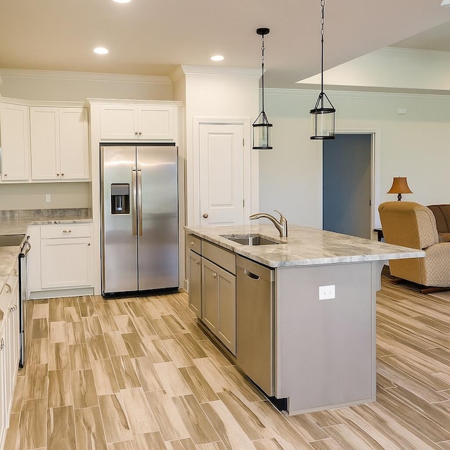 95 Santana Dr, Santa Rosa Beach, FL 32459 - kitchen with appliances with stainless steel finishes, crown molding, white cabinetry, light stone counters, and pendant lighting
