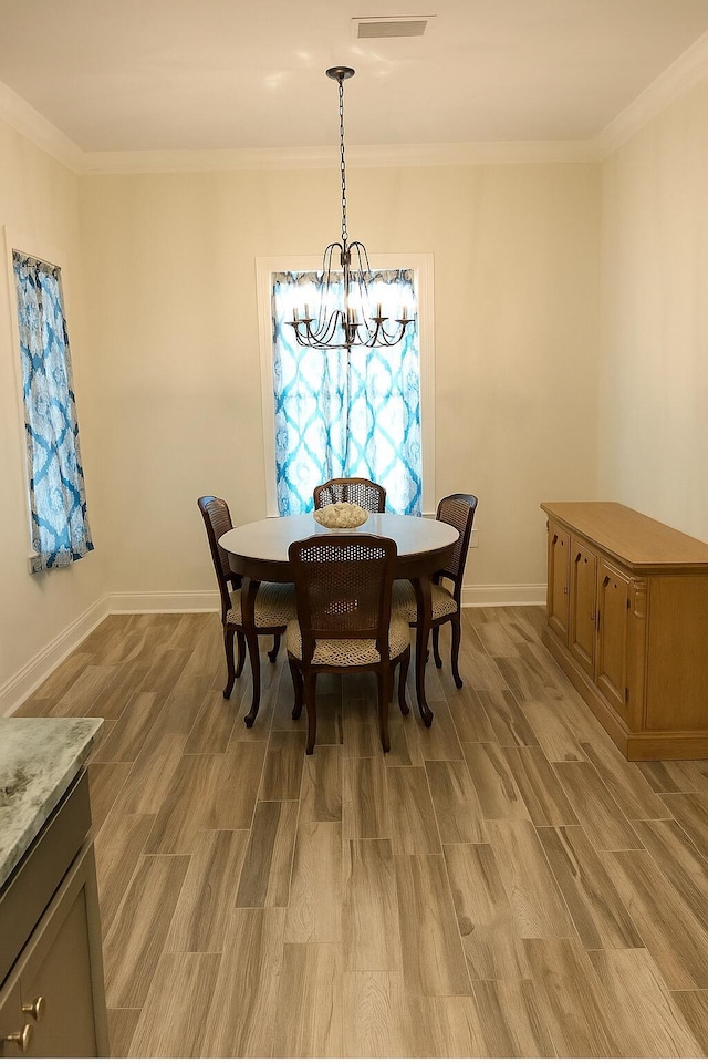 95 Santana Dr, Santa Rosa Beach, FL 32459 - dining space with a chandelier, light wood-type flooring, and crown molding