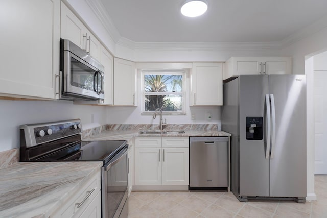330 Bluefish Dr Unit 119, Fort Walton Beach, FL 32548 - kitchen featuring stainless steel appliances, a sink, white cabinetry, crown molding, and light stone counters