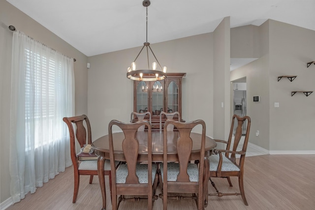 712 Riva Ridge Dr, Crestview, FL 32539 - dining room with vaulted ceiling, a chandelier, and light wood-style flooring