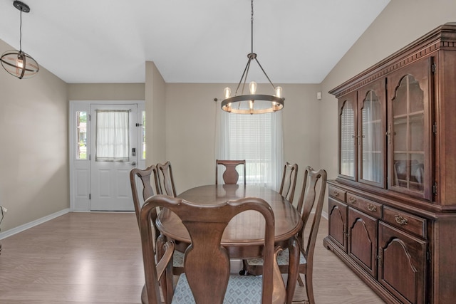 712 Riva Ridge Dr, Crestview, FL 32539 - dining space featuring light wood-style floors, a chandelier, and lofted ceiling