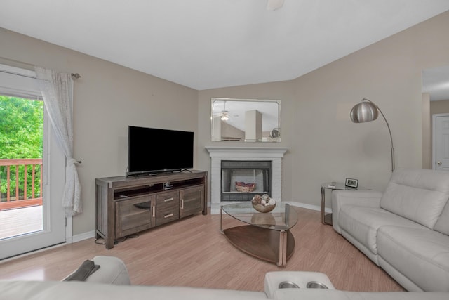 712 Riva Ridge Dr, Crestview, FL 32539 - living area featuring a brick fireplace, lofted ceiling, light wood finished floors, and a ceiling fan