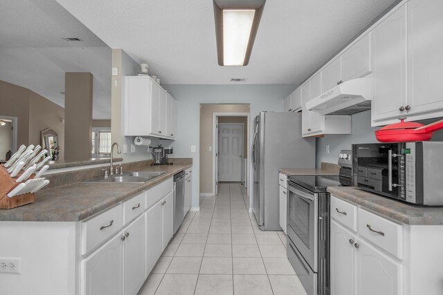 712 Riva Ridge Dr, Crestview, FL 32539 - kitchen with under cabinet range hood, stainless steel appliances, white cabinetry, and light tile patterned flooring