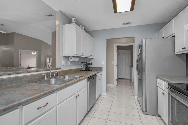 712 Riva Ridge Dr, Crestview, FL 32539 - kitchen with appliances with stainless steel finishes, white cabinetry, and light tile patterned flooring