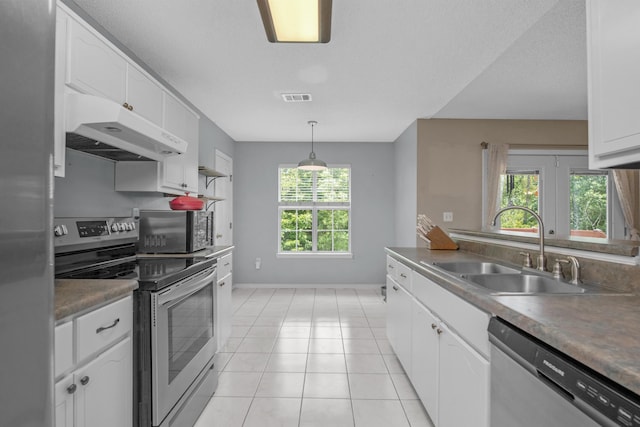 712 Riva Ridge Dr, Crestview, FL 32539 - kitchen featuring appliances with stainless steel finishes, under cabinet range hood, white cabinets, and light tile patterned floors