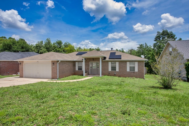712 Riva Ridge Dr, Crestview, FL 32539 - ranch-style home featuring an attached garage, brick siding, concrete driveway, solar panels, and a front lawn