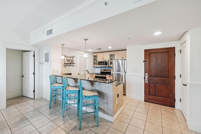 9100 Baytowne Wharf Blvd Unit 366-8, Miramar Beach, FL 32550 - kitchen with stainless steel appliances, a peninsula, a kitchen bar, glass insert cabinets, and light tile patterned floors