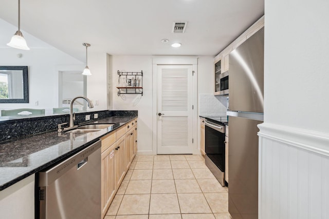 9100 Baytowne Wharf Blvd Unit 366-8, Miramar Beach, FL 32550 - kitchen with stainless steel appliances, a sink, light tile patterned floors, hanging light fixtures, and light brown cabinetry