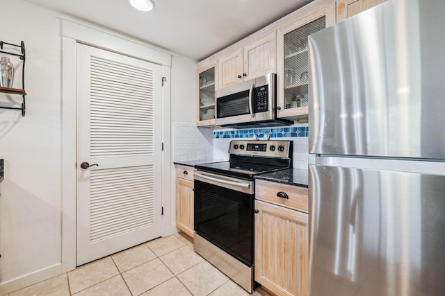 9100 Baytowne Wharf Blvd Unit 366-8, Miramar Beach, FL 32550 - kitchen featuring appliances with stainless steel finishes, glass insert cabinets, light brown cabinets, light tile patterned floors, and tasteful backsplash