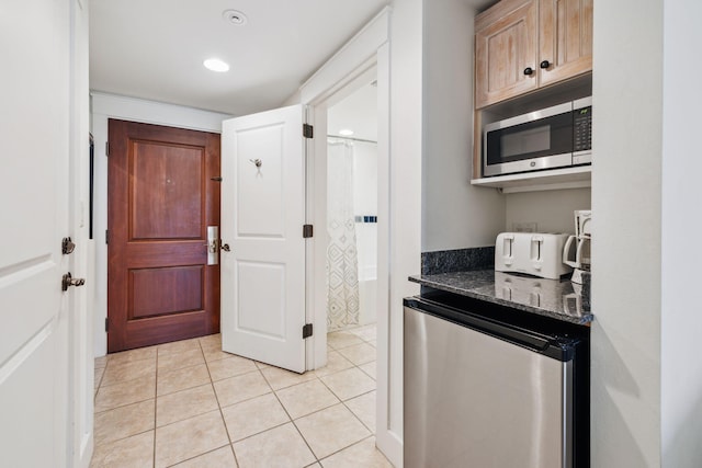 9100 Baytowne Wharf Blvd Unit 366-8, Miramar Beach, FL 32550 - kitchen featuring stainless steel appliances, light tile patterned floors, and dark stone counters