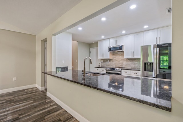 6859 Bill Lundy Rd, Laurel Hill, FL 32567 - kitchen with a sink, appliances with stainless steel finishes, dark wood finished floors, baseboards, and dark stone counters