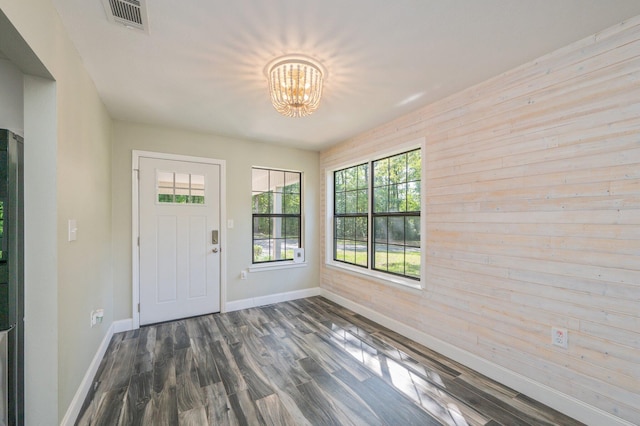 6859 Bill Lundy Rd, Laurel Hill, FL 32567 - entrance foyer featuring baseboards, a chandelier, dark wood-style flooring, and wooden walls