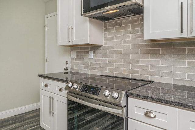 6859 Bill Lundy Rd, Laurel Hill, FL 32567 - kitchen featuring appliances with stainless steel finishes, tasteful backsplash, white cabinetry, and dark stone countertops