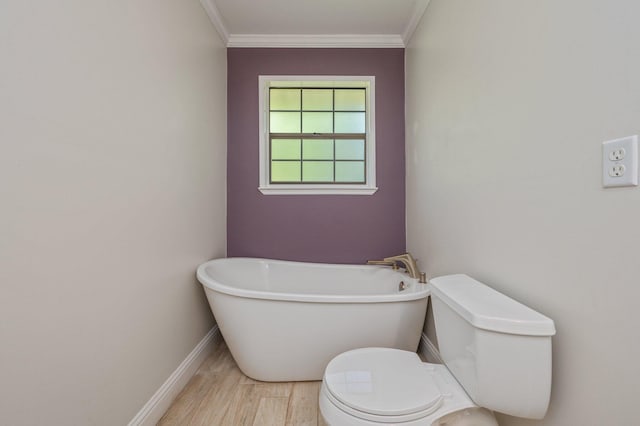 6859 Bill Lundy Rd, Laurel Hill, FL 32567 - bathroom with a freestanding tub, baseboards, toilet, crown molding, and wood finished floors