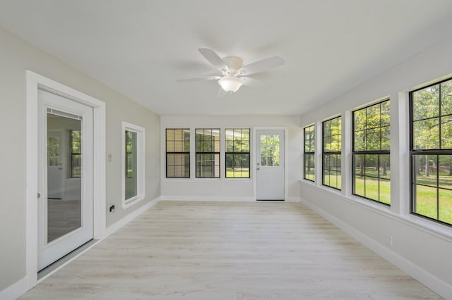 6859 Bill Lundy Rd, Laurel Hill, FL 32567 - unfurnished sunroom featuring healthy amount of natural light, wood finished floors, and baseboards