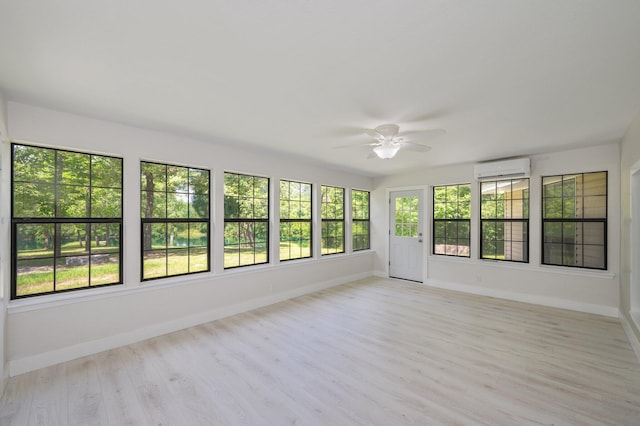 6859 Bill Lundy Rd, Laurel Hill, FL 32567 - unfurnished sunroom with baseboards, wood finished floors, and a wall unit AC