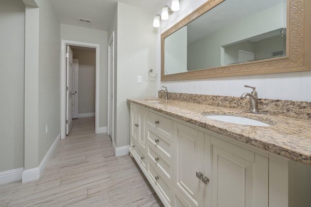 6859 Bill Lundy Rd, Laurel Hill, FL 32567 - full bathroom featuring double vanity, baseboards, wood finished floors, and backsplash
