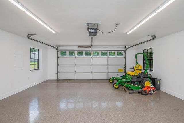 6859 Bill Lundy Rd, Laurel Hill, FL 32567 - garage with baseboards, a garage door opener, and electric panel