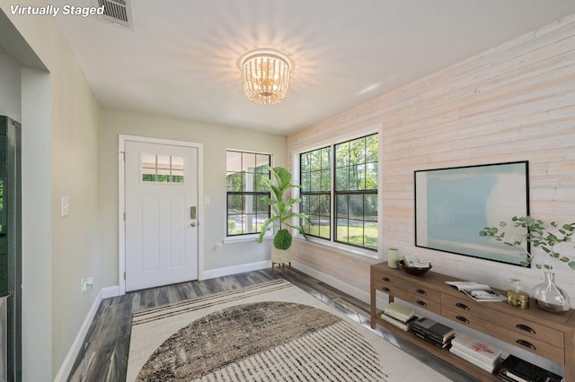 6859 Bill Lundy Rd, Laurel Hill, FL 32567 - foyer entrance with wood finished floors, a chandelier, and wooden walls