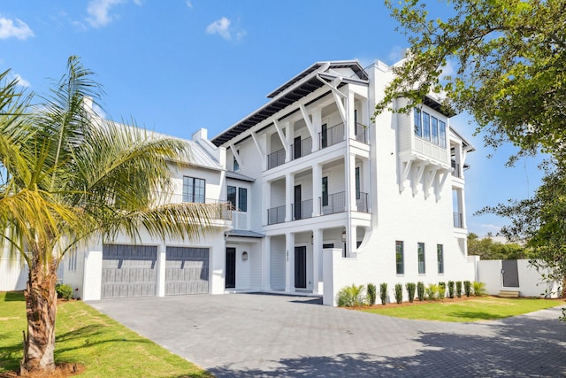 5012 W County Highway 30a, Santa Rosa Beach, FL 32459 - view of front facade featuring a balcony, driveway, and an attached garage