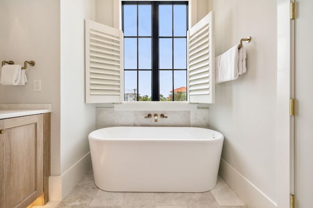 5012 W County Highway 30a, Santa Rosa Beach, FL 32459 - full bathroom featuring a freestanding bath, vanity, and baseboards