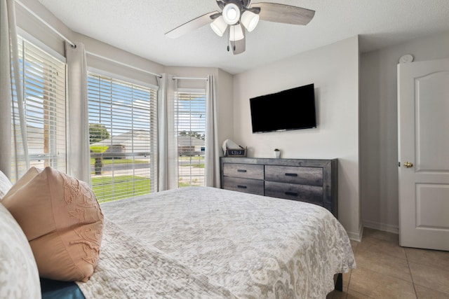 187 Sandy Cay Dr, Miramar Beach, FL 32550 - bedroom with light tile patterned flooring, baseboards, a ceiling fan, and a textured ceiling
