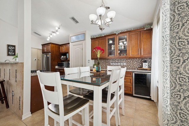 187 Sandy Cay Dr, Miramar Beach, FL 32550 - dining room featuring beverage cooler, vaulted ceiling, a chandelier, and light tile patterned floors