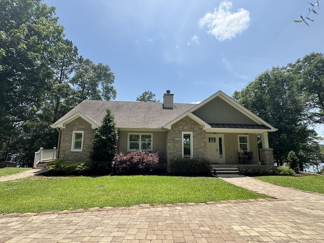 275 Lake Holley Cir, Defuniak Springs, FL 32433 - craftsman house featuring stone siding, a chimney, a porch, and a front yard