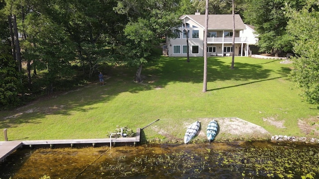 275 Lake Holley Cir, Defuniak Springs, FL 32433 - view of green lawn featuring a water view and a boat dock