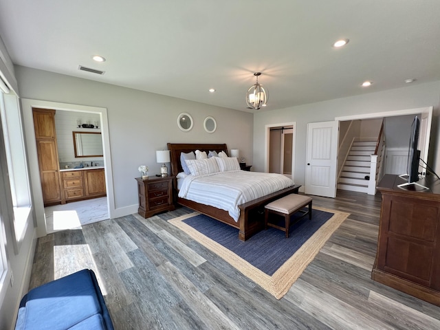 275 Lake Holley Cir, Defuniak Springs, FL 32433 - bedroom with wood finished floors, recessed lighting, a chandelier, connected bathroom, and baseboards