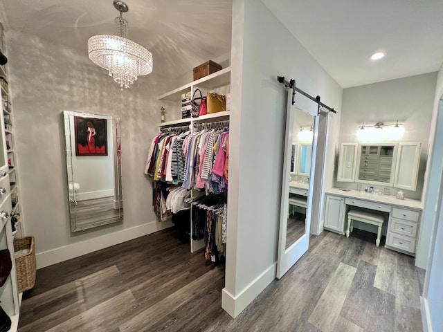 275 Lake Holley Cir, Defuniak Springs, FL 32433 - walk in closet featuring a barn door, wood finished floors, and a chandelier