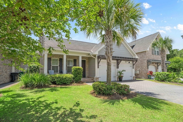 327 Cobalt Ln, Miramar Beach, FL 32550 - view of front of property with decorative driveway, a front yard, a garage, a porch, and a shingled roof