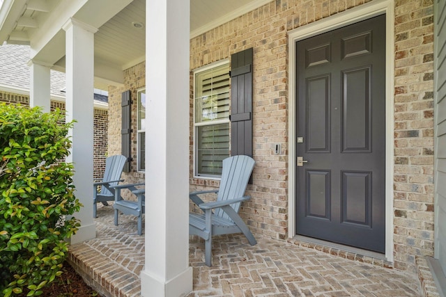 327 Cobalt Ln, Miramar Beach, FL 32550 - property entrance with a porch and brick siding