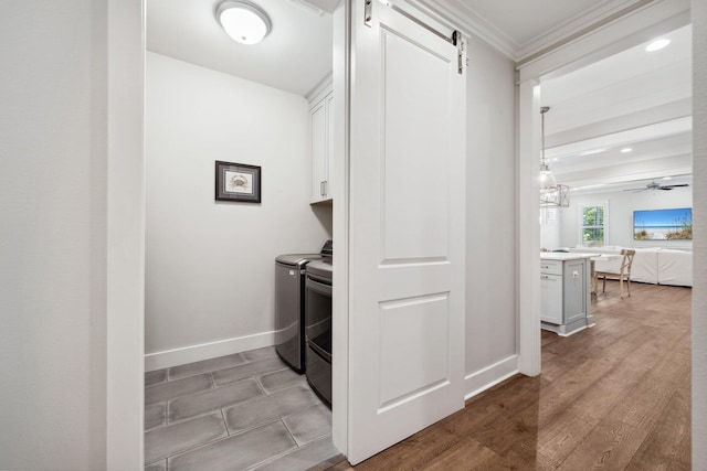 327 Cobalt Ln, Miramar Beach, FL 32550 - clothes washing area with cabinet space, separate washer and dryer, crown molding, a barn door, and baseboards