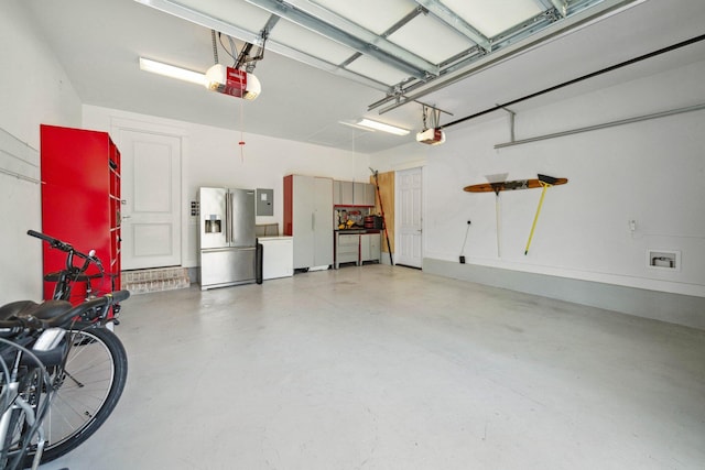327 Cobalt Ln, Miramar Beach, FL 32550 - garage with stainless steel refrigerator with ice dispenser, a garage door opener, and electric panel